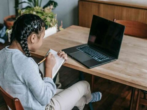 A lady studying on a laptop